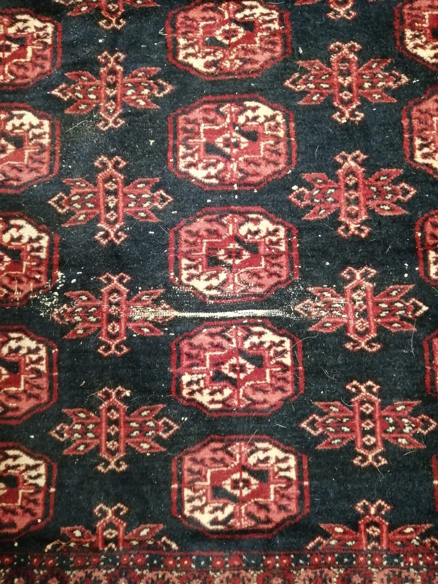 A Bokhara blue ground carpet, 370 x 280cm